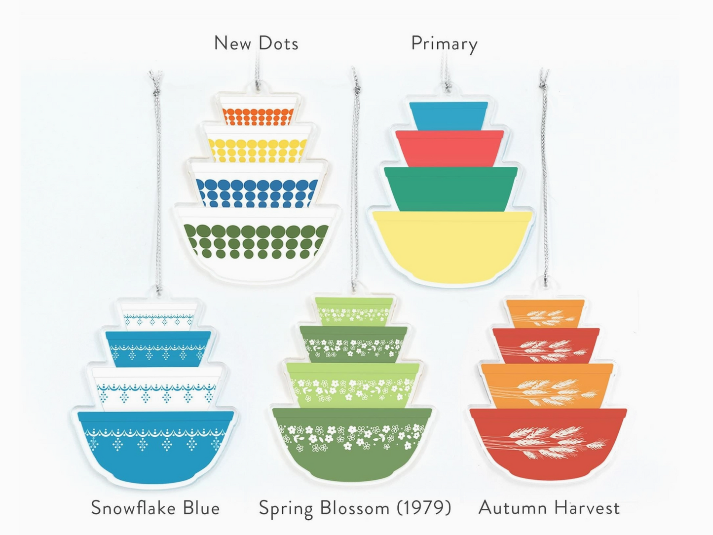 Set of colorful stacking bowls with patterned designs on a white background