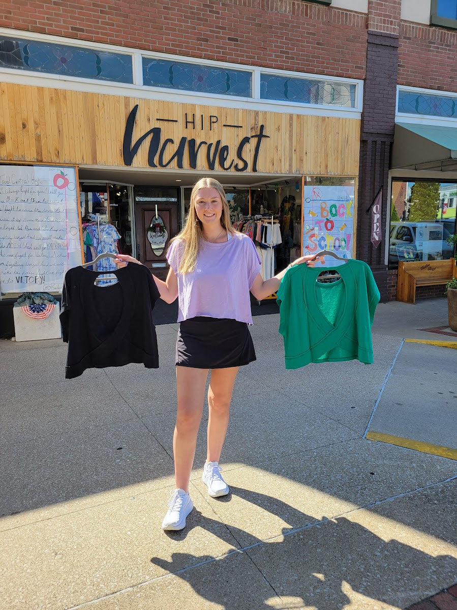Person holding black and green shirt in front of local shop in elkton, ky