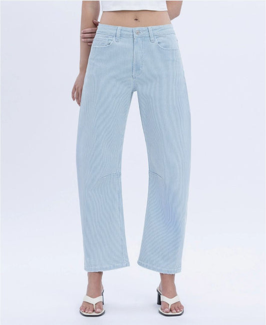 Light blue jeans worn by a person on a white background