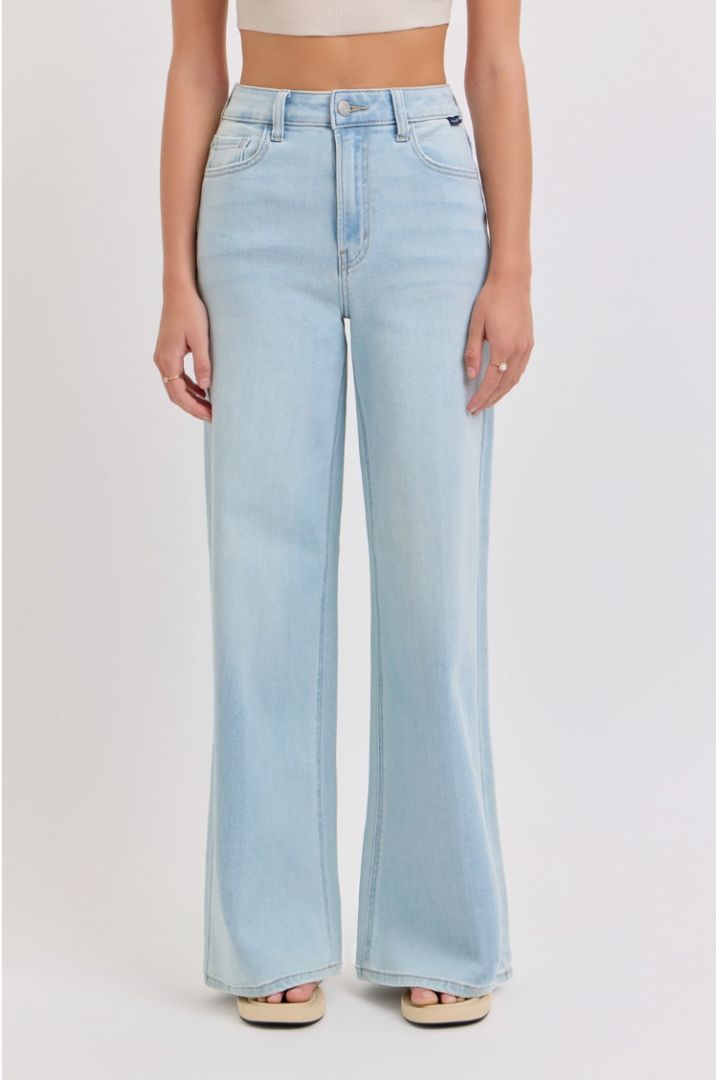 Light blue jeans worn by a person on a plain background