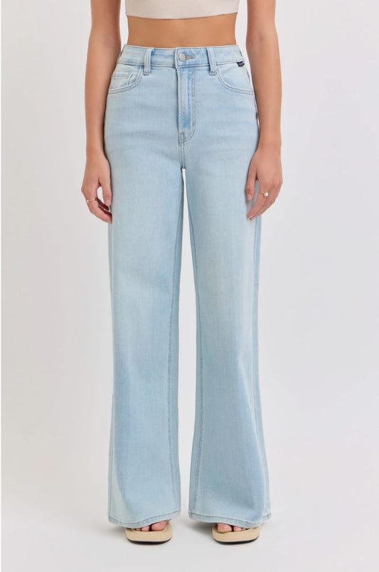 Light blue jeans worn by a person on a plain background