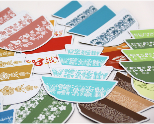 Collection of colorful patterned magnets on a white background